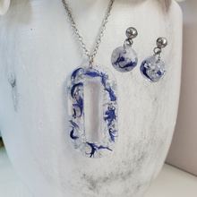 Load image into Gallery viewer, Handmade real flower oval pendant necklace accompanied by a pair of circular stud earrings made with blue cornflower and silver flakes. Jewelry Sets, Flower Jewelry, Necklace Set