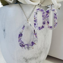 Load image into Gallery viewer, Handmade real flower teardrop pendant necklace accompanied by a pair of oval stud earrings made with purple statice and silver flakes preserved in resin. Necklace And Earring Set, Resin Flower Jewelry