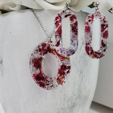 Load image into Gallery viewer, Handmade real flower oval pendant necklace accompanied by a pair of stud dangling earrings made with rose petals and silver flakes preserved in resin. Resin Flower Jewelry - Necklace And Earring Set