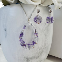 Load image into Gallery viewer, Handmade real flower teardrop pendant necklace accompanied by a pair of circular stud earrings made with purple statice and silver flakes preserved in resin. Jewelry Sets, Flower Jewelry, Resin Jewelry