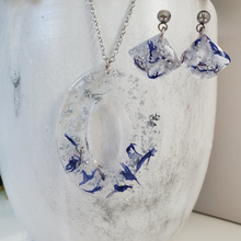 Load image into Gallery viewer, Handmade real flower oval pendant necklace accompanied by a pair of shell shape stud earrings made with blue cornflower and silver flakes preserved in resin. - Jewelry Sets, Flower Jewelry, Blue Jewelry
