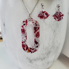 Load image into Gallery viewer, Handmade real flower oval pendant necklace accompanied by a matching pair of dangling stud earrings made with rose petals and silver flakes preserved in resin. - Red Jewelry, Jewelry Sets, Flower Jewelry