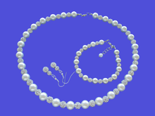 Load image into Gallery viewer, A handmade pearl and crystal necklace accompanied by a matching bracelet and a pair of crystal drop earrings. 