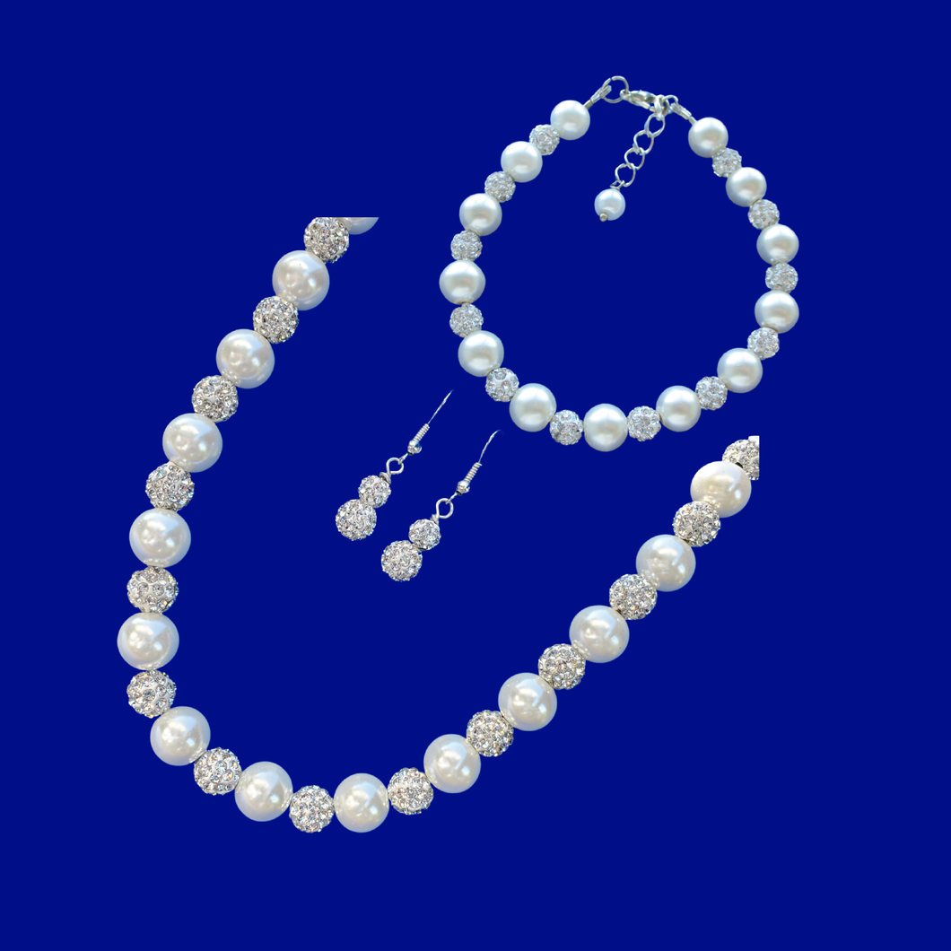 A handmade pearl and crystal necklace accompanied by a matching bracelet and a pair of crystal drop earrings.