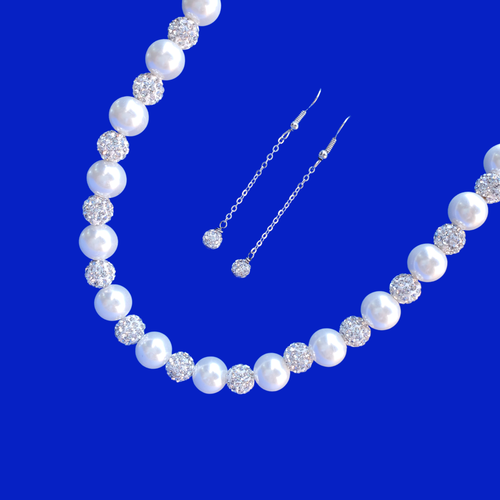 A handmade pearl and crystal necklace accompanied by a pair of crystal drop earrings.