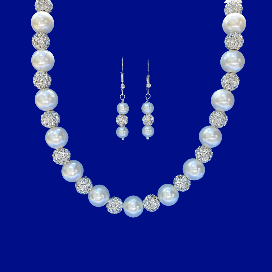 A handmade pave crystal and pearl necklace accompanied by a pair of drop earrings.
