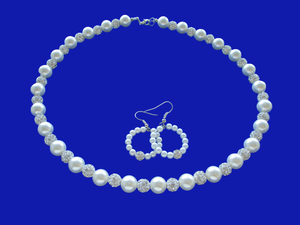 A handmade pearl and crystal necklace accompanied by a pair of hoop earrings.