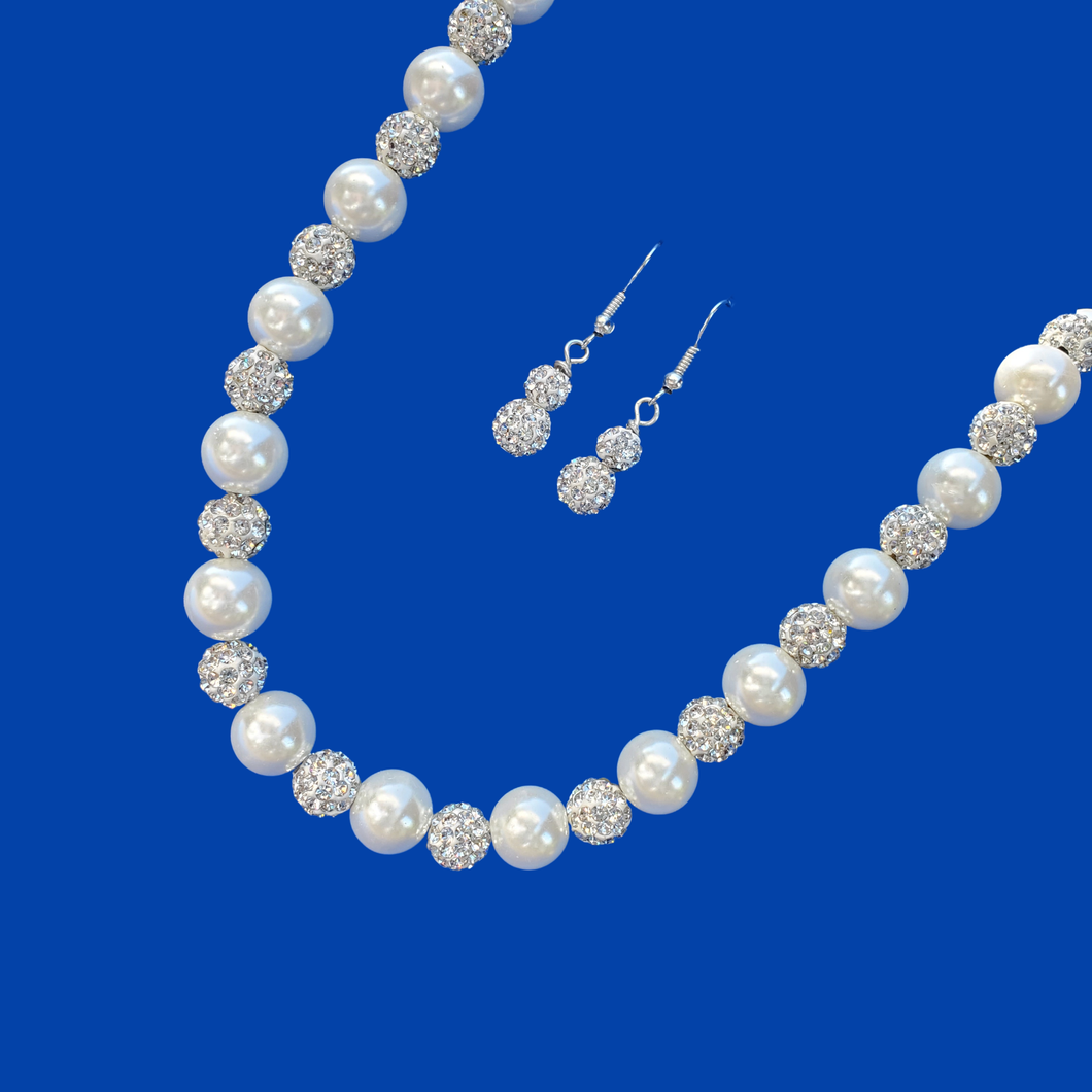 A handmade pearl and crystal necklace accompanied by a pair of crystal earrings.