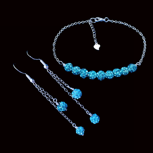 handmade crystal bar bracelet accompanied by a pair of multi-strand drop earrings