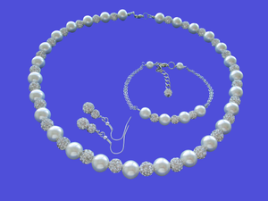 A handmade pearl and crystal necklace accompanied by a bar bracelet and a pair of crystal drop earrings. 