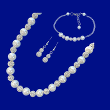Load image into Gallery viewer, A handmade pearl and crystal necklace accompanied by a bar bracelet and a pair of crystal drop earrings.