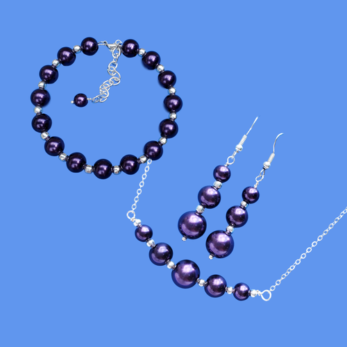 handmade silver accented bar necklace accompanied by a bracelet and a pair of drop earrings