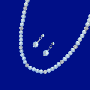 handmade pearl and crystal necklace accompanied by a pair of pearl stud earrings