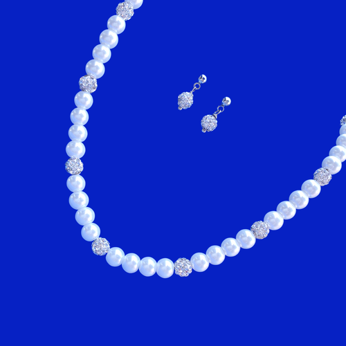 A handmade pearl and crystal necklace accompanied by a pair of crystal stud earrings.