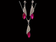 Load image into Gallery viewer, A crystal teardrop drop necklace accompanied by a pair of matching earrings.