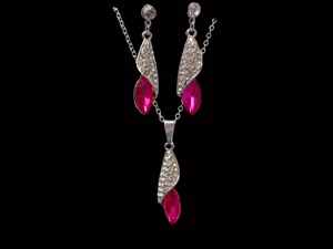 A crystal teardrop drop necklace accompanied by a pair of matching earrings.