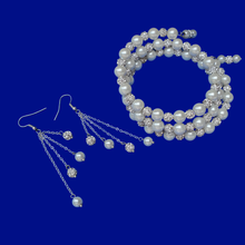 Load image into Gallery viewer, A handmade pearl and crystal expandable, multi-layer, wrap bracelet accompanied by a pair of multi-strand drop earrings.