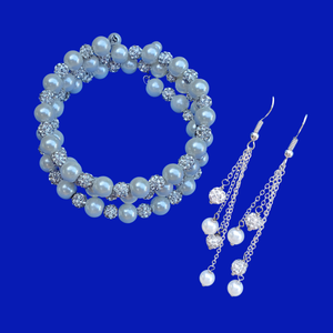 A handmade pearl and crystal expandable, multi-layer, wrap bracelet accompanied by a pair of multi-strand drop earrings.
