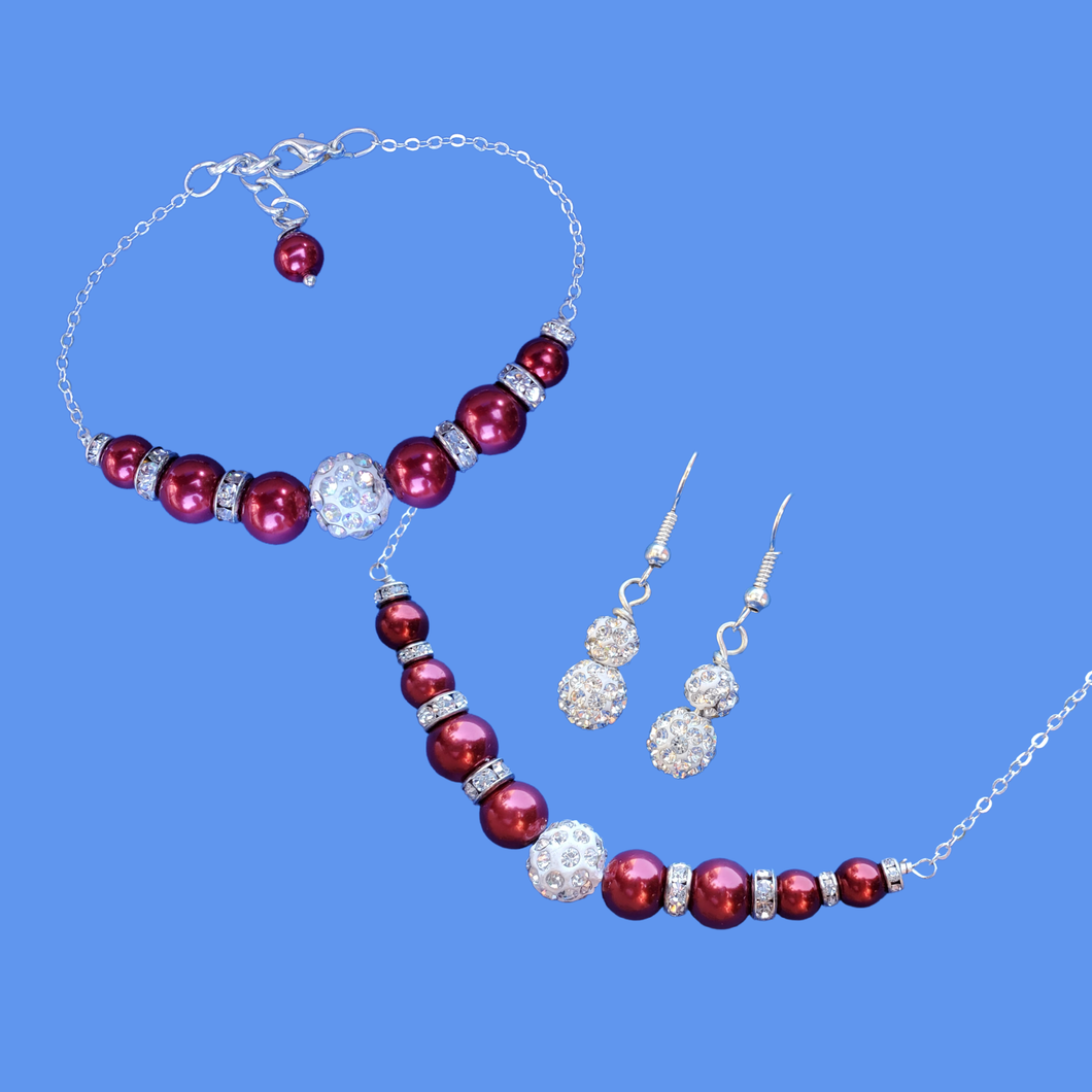 andmade pearl and crystal bar necklace accompanied by a matching bracelet and a pair of crystal drop earrings