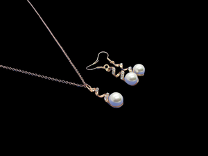 spiral drop necklace and earring jewelry set with an inset pearl 
