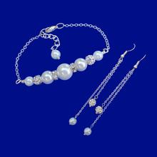 Load image into Gallery viewer, pearl and crystal bar bracelet accompanied by a matching pair of multi-strand drop earrings