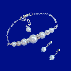 handmade pearl and crystal bar bracelet accompanied by a pair of pearl stud earrings