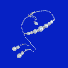 Load image into Gallery viewer,  handmade pearl and crystal bar bracelet accompanied by a pair of drop earrings
