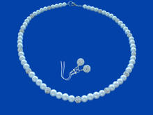 Load image into Gallery viewer, A handmade pearl and crystal necklace accompanied by a pair of crystal earrings.