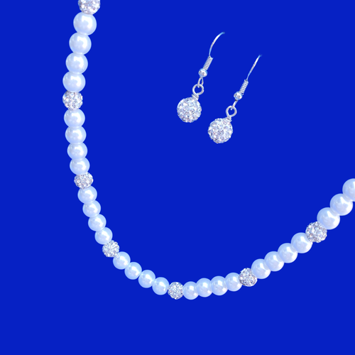 A handmade pearl and crystal necklace accompanied by a pair of crystal drop earrings.