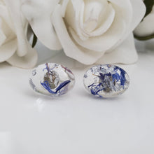 Load image into Gallery viewer, Flower Stud Earrings, Earrings, Oval Earrings - handmade resin oval stud earrings with blue cornflower petals and silver flakes