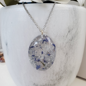 Pendant Necklace - Necklaces - Flower Necklace - Handmade resin oval necklace with real blue status flowers and silver flakes.
