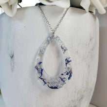 Load image into Gallery viewer, Handmade real flower resin teardrop necklace made with blue cornflower and silver flakes. -  Teardrop Necklace, Flower Necklace, Necklaces
