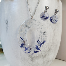 Load image into Gallery viewer, Handmade real flower oval drop pendant necklace accompanied by a by of dangling stud earrings made with blue cornflower and silver flakes preserved in resin. - Flower Jewelry, Bridesmaid Gifts, Jewelry Sets