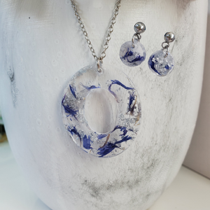 Handmade real flower oval drop pendant necklace accompanied by a pair of dangling stud circular earrings made with blue cornflower and silver flakes preserved in resin. - Jewelry Sets, Flower Jewelry, Bridesmaid Gifts