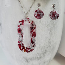 Load image into Gallery viewer, Handmade real flower oval pendant necklace accompanied by a pair of circular stud earrings made with rose petals and silver flakes. Jewelry Sets, Flower Jewelry, Necklace Set