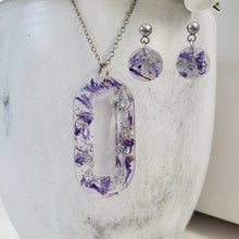 Load image into Gallery viewer, Handmade real flower oval pendant necklace accompanied by a pair of circular stud earrings made with purple statice and silver flakes. Jewelry Sets, Flower Jewelry, Necklace Set
