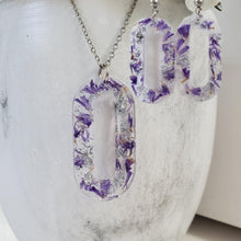 Load image into Gallery viewer, Handmade real flower oval pendant necklace accompanied by a matching pair of dangling stud earrings made with purple statice and silver flakes preserved in resin. - Jewelry Sets, Resin Flower Jewelry, Necklace Set