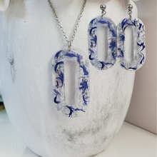 Load image into Gallery viewer, Handmade real flower oval pendant necklace accompanied by a matching pair of dangling stud earrings made with blue cornflower and silver flakes preserved in resin. - Jewelry Sets, Resin Flower Jewelry, Necklace Set
