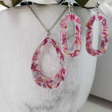 Load image into Gallery viewer, Handmade real flower teardrop pendant necklace accompanied by a pair of oval stud earrings made with red clover flowers and silver flakes preserved in resin. Necklace And Earring Set, Resin Flower Jewelry