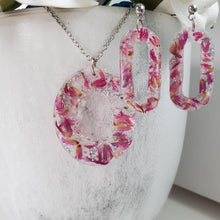 Load image into Gallery viewer, Handmade real flower oval pendant necklace accompanied by a pair of stud dangling earrings made with red clover flowers and silver flakes preserved in resin. Resin Flower Jewelry - Necklace And Earring Set