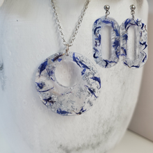 Load image into Gallery viewer, Handmade real flower circular pendant necklace accompanied by a pair of oval stud drop earrings made with blue cornflower and silver flakes preserved in resin. Resin Flower Jewelry, Bridal Sets, Jewelry Sets