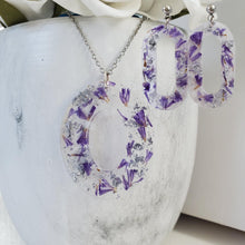 Load image into Gallery viewer, Handmade real flower oval pendant necklace accompanied by a pair of oval stud earrings made with purple statice and silver flakes preserved in resin. Necklace Set - Resin Flower Jewelry - Flower Jewelry