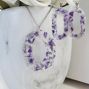 Handmade real flower oval pendant necklace accompanied by a pair of oval stud earrings made with purple statice and silver flakes preserved in resin. Necklace Set - Resin Flower Jewelry - Flower Jewelry