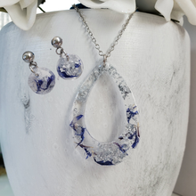Load image into Gallery viewer, Handmade real flower teardrop pendant necklace accompanied by a pair of circular stud earrings made with blue cornflower and silver flakes preserved in resin. Jewelry Sets, Flower Jewelry, Resin Jewelry