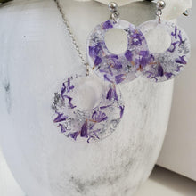 Load image into Gallery viewer, Handmade real flower circular pendant necklace accompanied by a matching pair of earrings made with purple statice and silver flakes preserved in resin - Dried Flower Jewelry, Bridal Gifts, Jewelry Sets