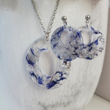 Load image into Gallery viewer, Handmade real flower oval pendant necklace accompanied by a pair of circular stud earrings made with blue cornflower and silver leaf preserved in resin. - Pressed Flower Jewelry, Flower Jewelry, Jewelry Sets