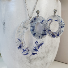 Load image into Gallery viewer, Handmade real flower oval pendant necklace accompanied by a pair of oval stud earrings made with blue cornflower and silver leaf preserved in resin.  - Flower Jewelry, Blue Jewelry, Jewelry Sets