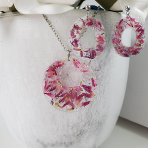 Handmade real flower circular pendant necklace accompanied by a pair of oval stud drop earrings made with red clover flowers and silver flakes preserved in resin. - Flower Jewelry, Red Jewelry, Jewelry Sets