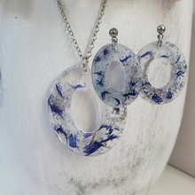 Load image into Gallery viewer, Handmade real flower oval pendant necklace accompanied by a matching pair of dangling stud earrings made with blue cornflowers and silver flakes preserved in resin. - Flower Jewelry, Pink Jewelry, Jewelry Sets