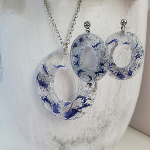 Handmade real flower oval pendant necklace accompanied by a matching pair of dangling stud earrings made with blue cornflowers and silver flakes preserved in resin. - Flower Jewelry, Pink Jewelry, Jewelry Sets
